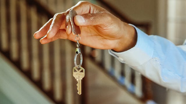 person holding house keys